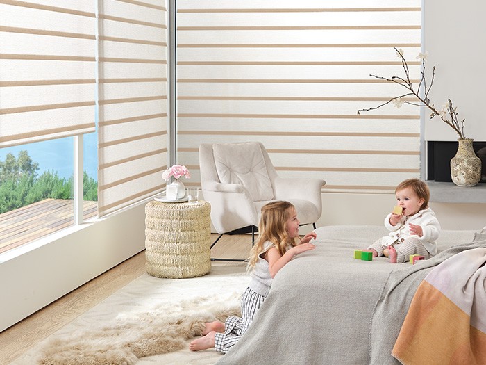 Children’s bedroom with windows featuring Vignette Modern Roman Shades with PowerView® Automation.